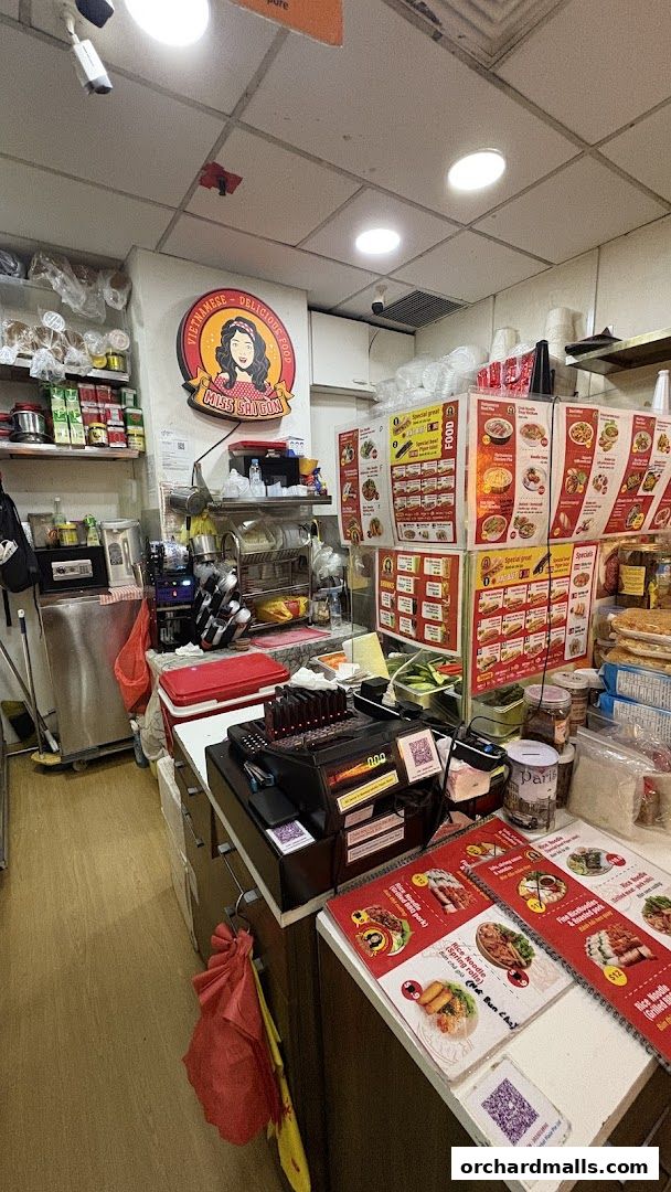 Interior view of Miss Saigon Singapore, a Vietnamese restaurant with menus and food displays.