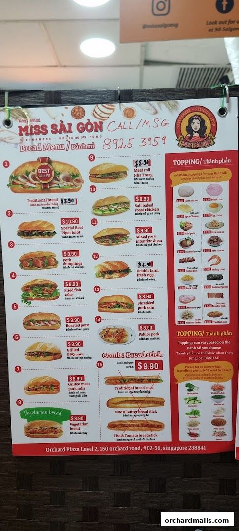 A menu board for Miss Saigon Singapore featuring various Banh Mi options and toppings.