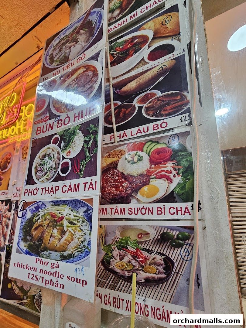 A display of Vietnamese dishes with images and prices, including pho and noodle soups.