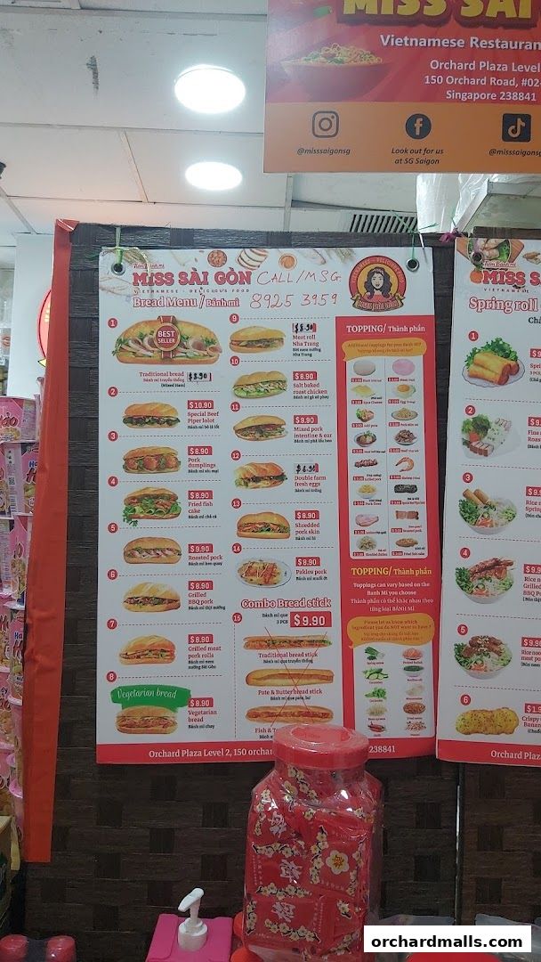 A menu board for Miss Saigon Singapore featuring Vietnamese bread and spring rolls.