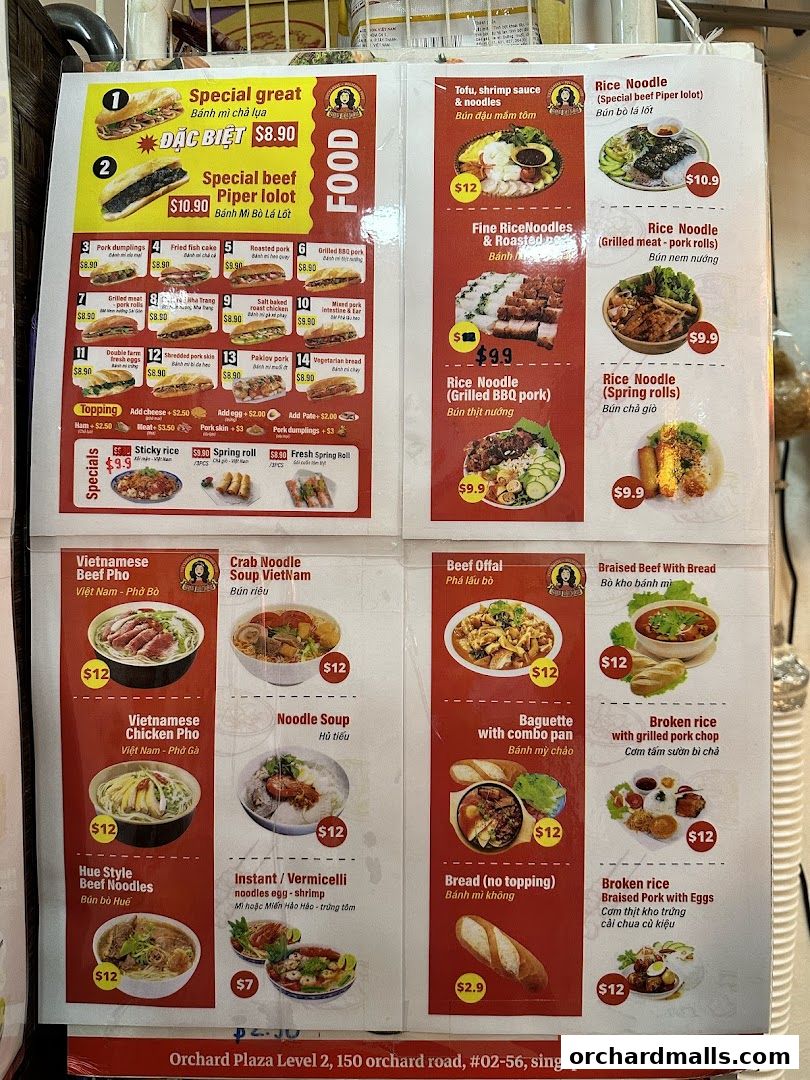 A menu board displaying various Vietnamese dishes including pho, banh mi, rice noodles, and broken rice.