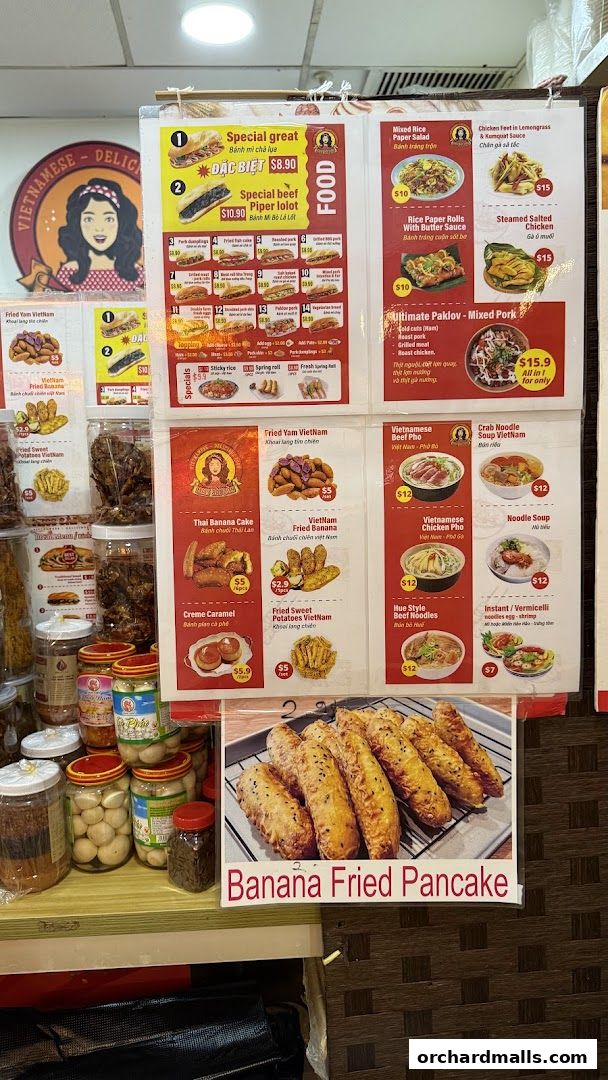 A menu board displaying various Vietnamese dishes and snacks with prices.
