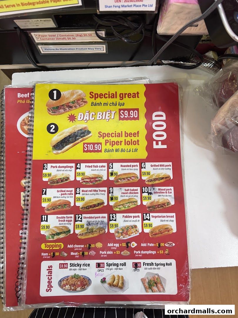 A menu featuring Vietnamese banh mi sandwiches, spring rolls, and sticky rice with prices.