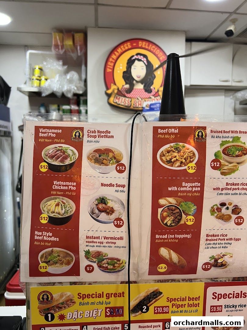 A menu display for Miss Saigon Singapore featuring Vietnamese dishes like Pho, noodles, and banh mi.
