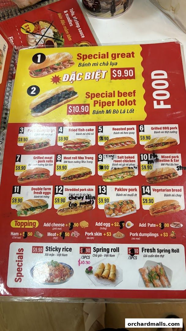 A menu displaying various Vietnamese banh mi sandwiches, specials, and toppings.