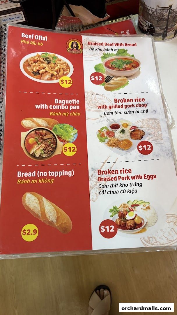 A menu from Miss Saigon Singapore featuring Vietnamese dishes like beef offal and broken rice.