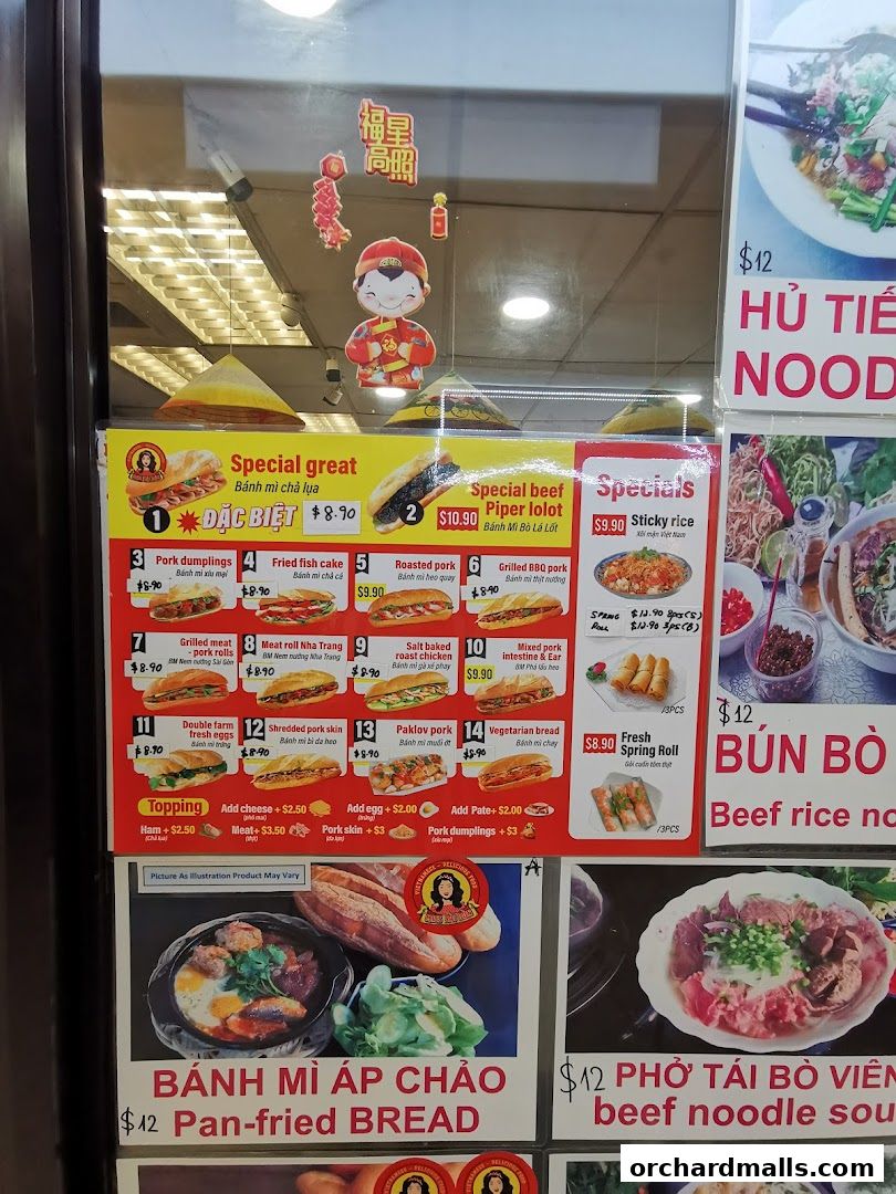 A menu board displaying various Vietnamese banh mi sandwiches and other dishes with prices.