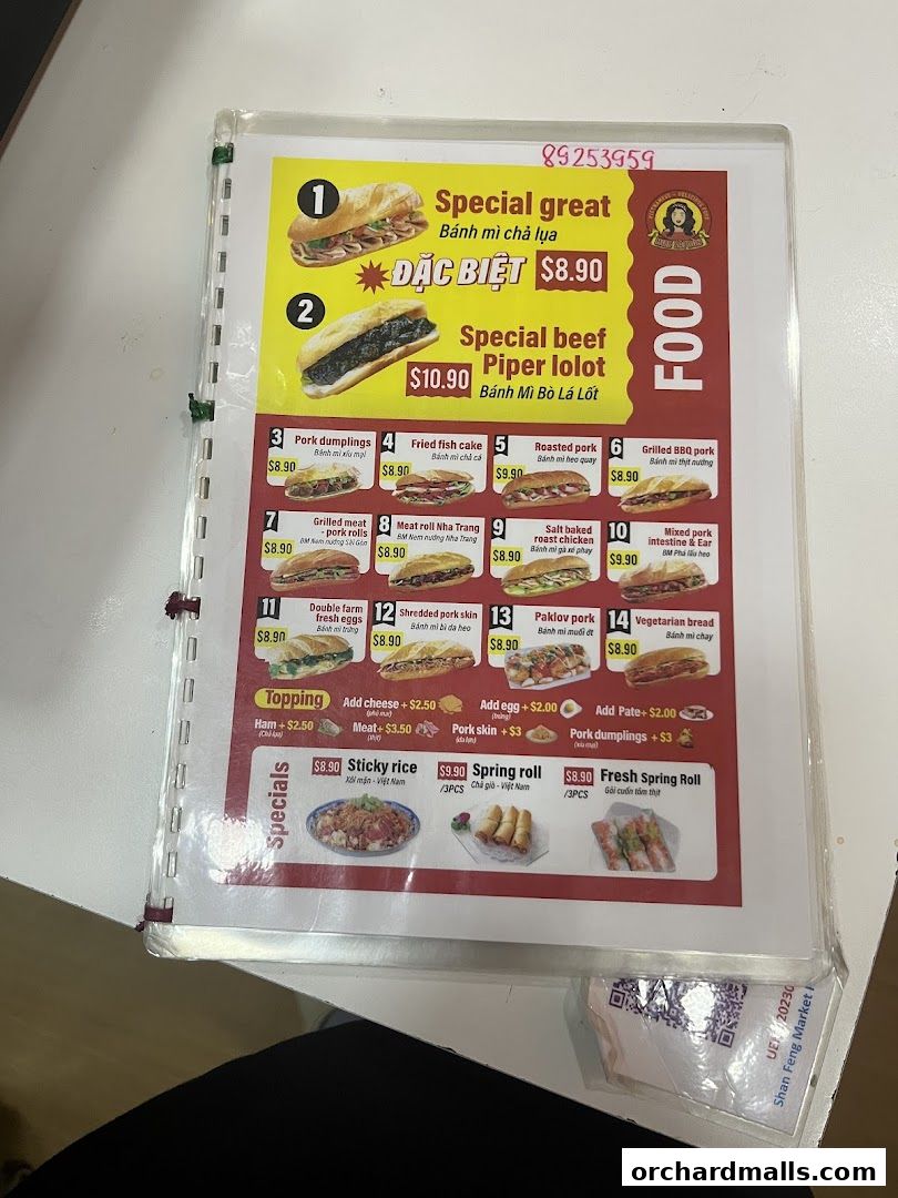 A menu from Miss Saigon Singapore featuring various banh mi, specials, and toppings.