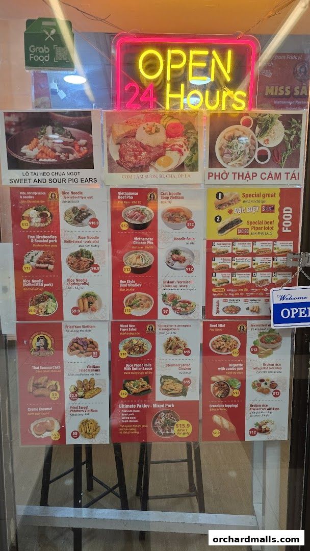 A menu board displaying various Vietnamese dishes with images and prices.