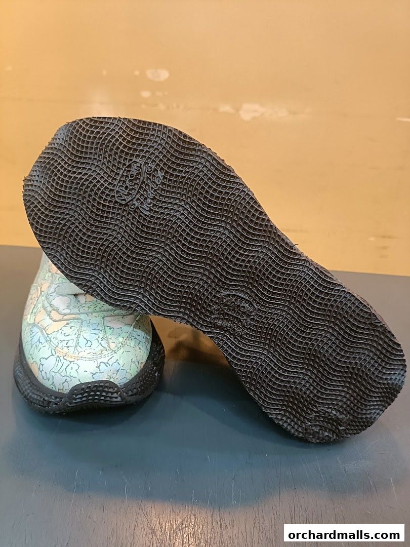 A pair of sneakers with a map-like pattern on the upper and a textured sole.