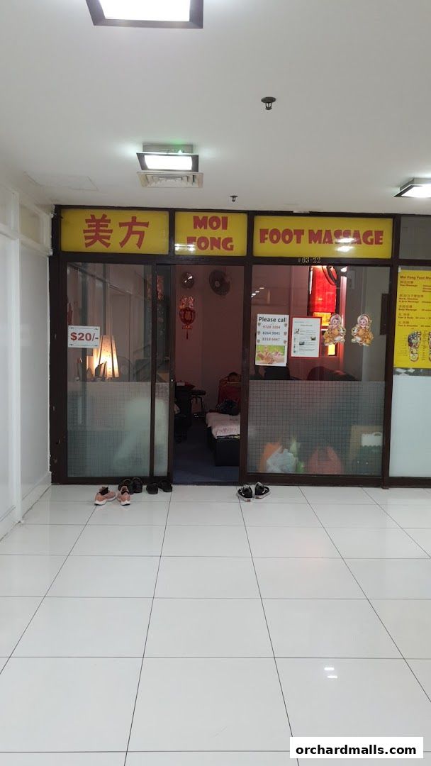 Exterior view of Moi Fong Foot Reflexology Center with signage and an open doorway.