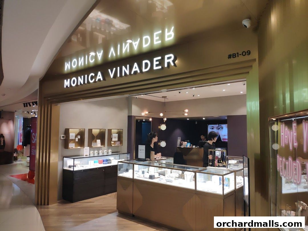 The Monica Vinader jewelry store entrance with illuminated signage and display cases.