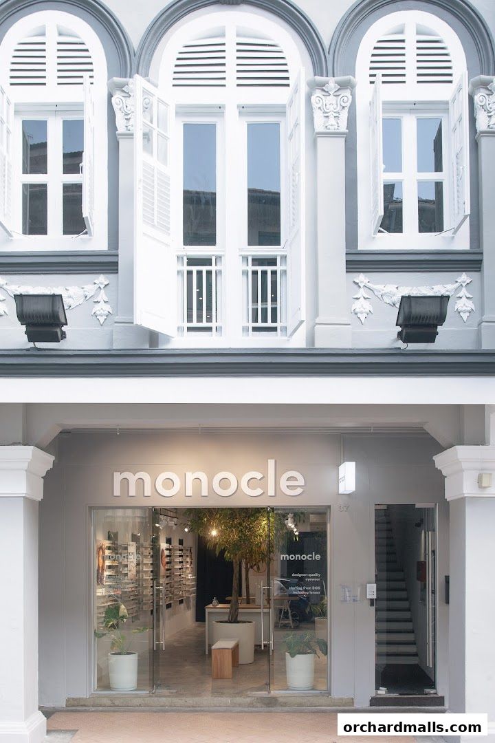 The Monocle shop front features a modern glass facade displaying eyewear and interior plants.