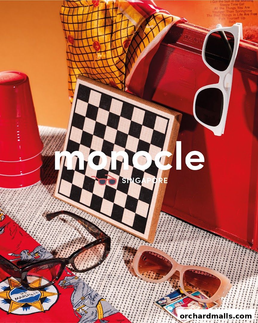 Monocle Singapore features stylish sunglasses, a chessboard, and vibrant accessories.
