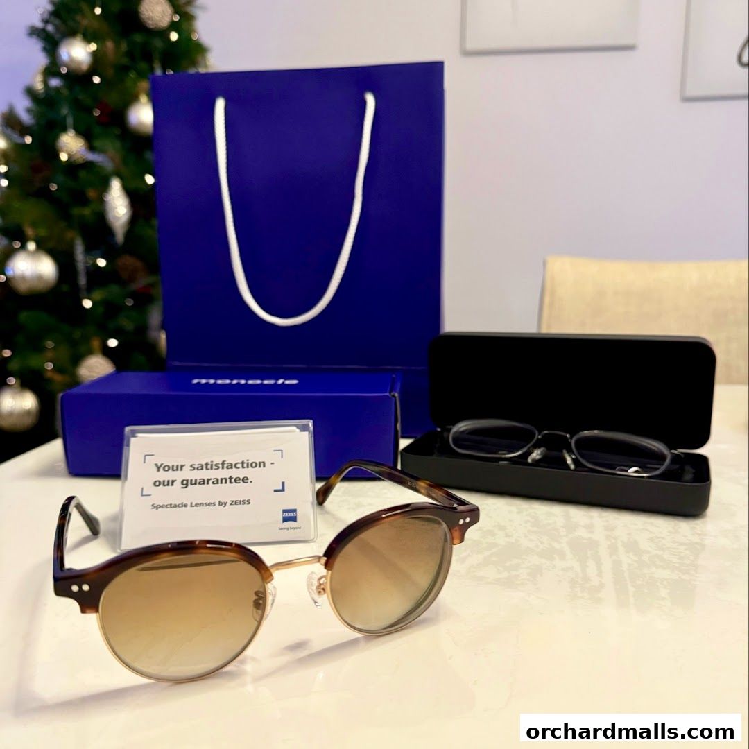 Monocle shop display featuring sunglasses, eyeglasses, and a shopping bag with a Christmas tree.
