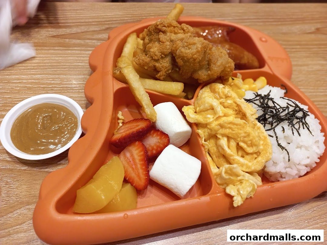 A colorful and appealing children's meal served on a dinosaur-shaped plate.