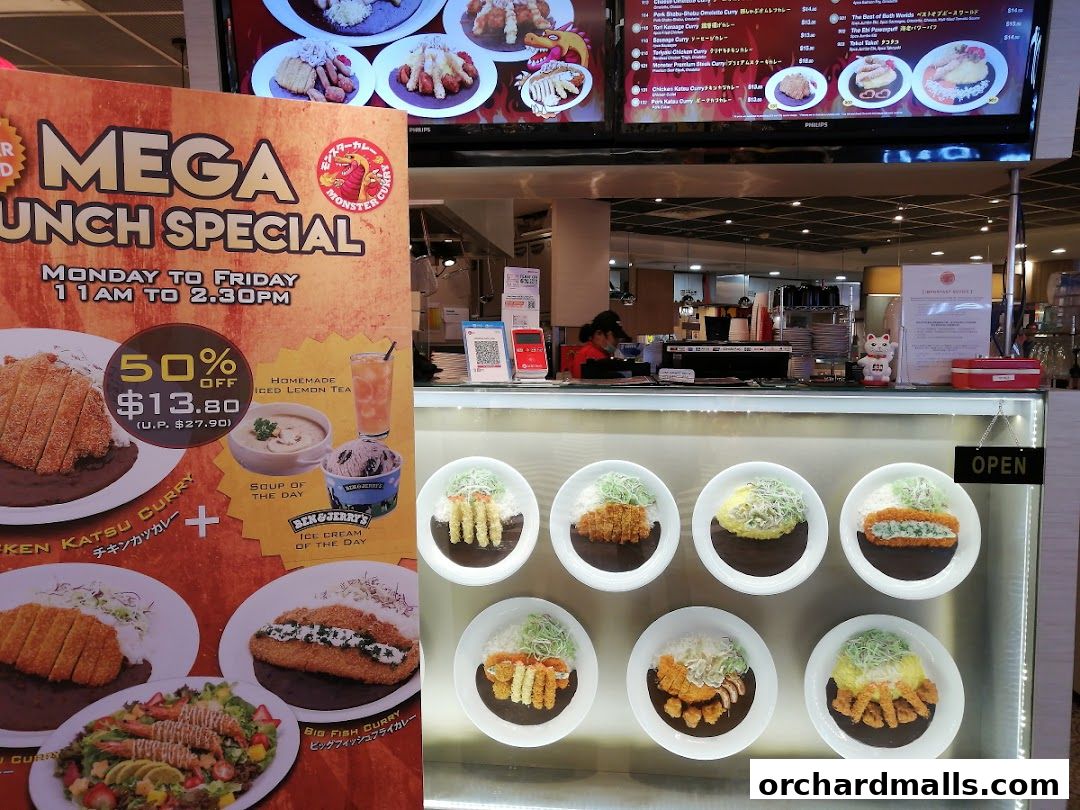 A Monster Curry shop display featuring a lunch special and various curry dishes.