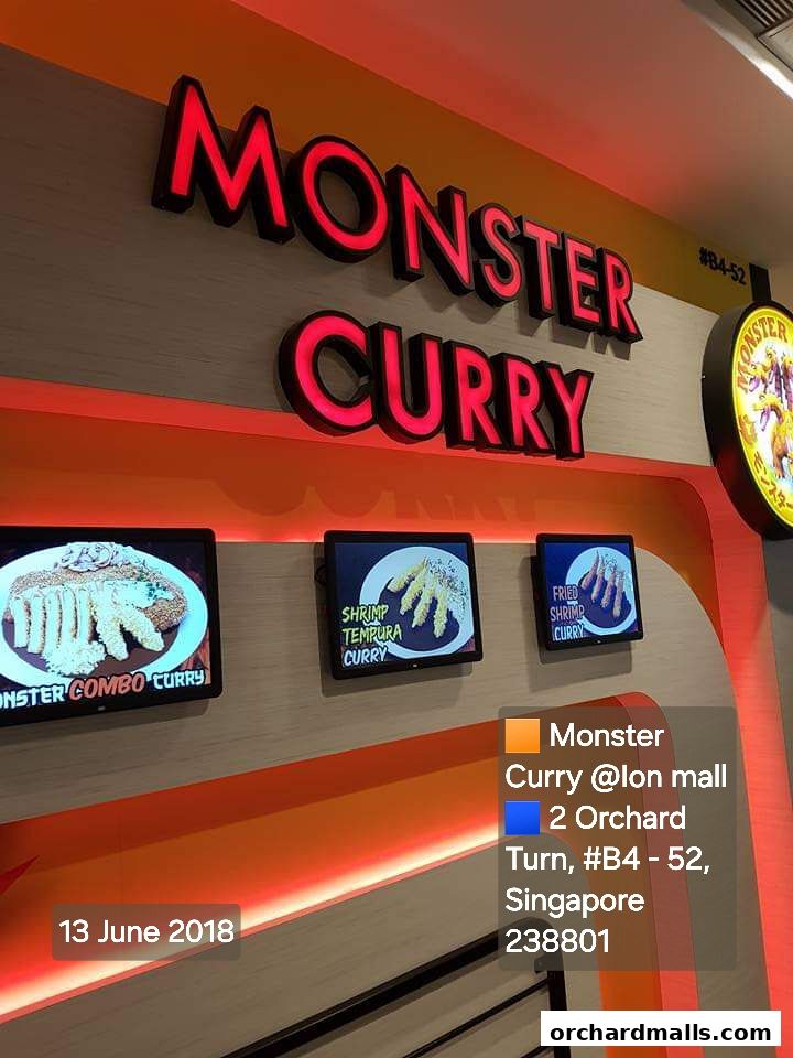 The exterior of Monster Curry at ION Orchard, showcasing its signage and menu displays.