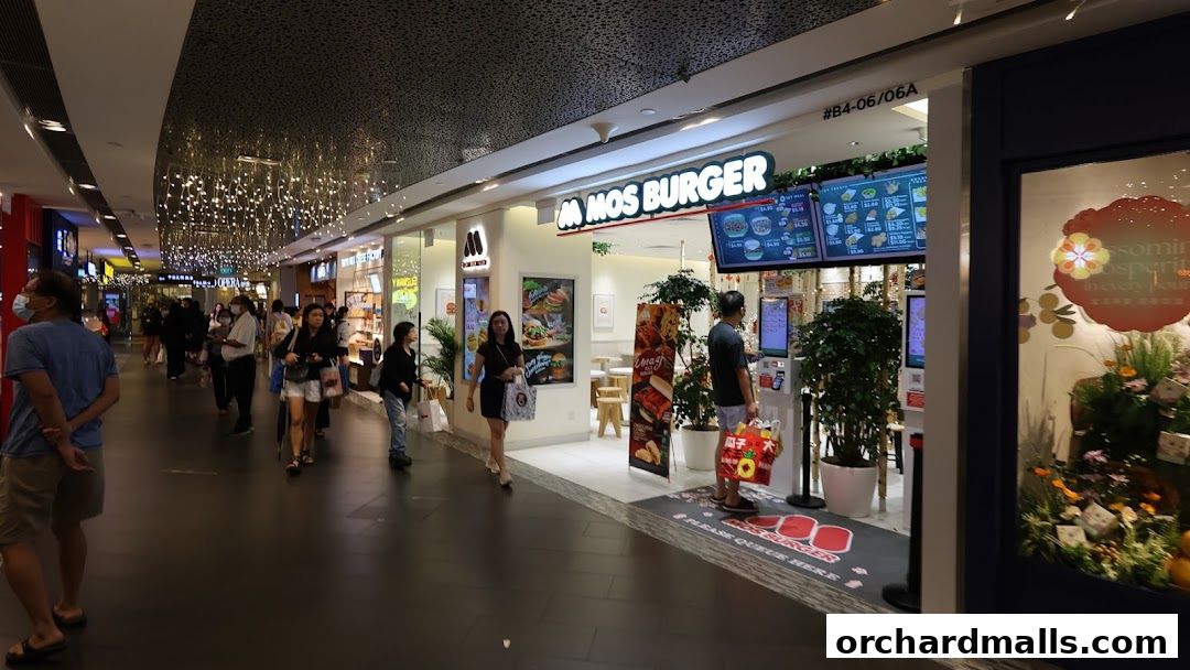 MOS Burger shop front with digital menus and customers ordering.