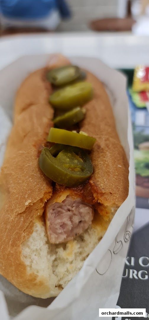 A close-up shot of a delicious MOS Burger hot dog with jalapeños.