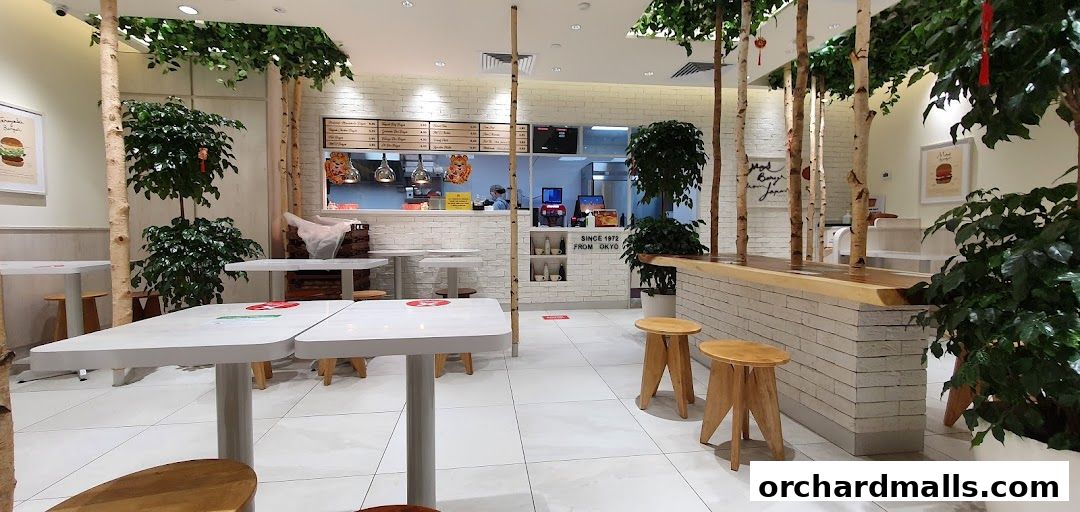 Interior of a MOS Burger restaurant with tables, chairs, and a counter.