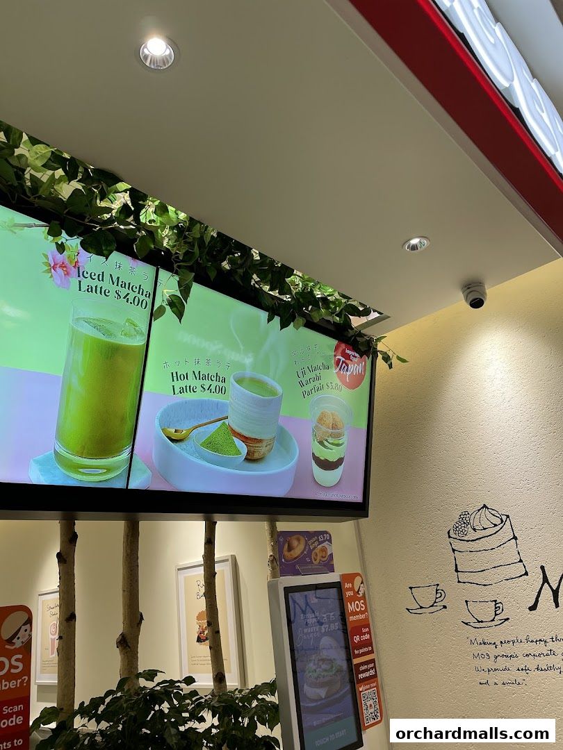 Digital menu board displaying various matcha drinks and desserts at MOS Burger.