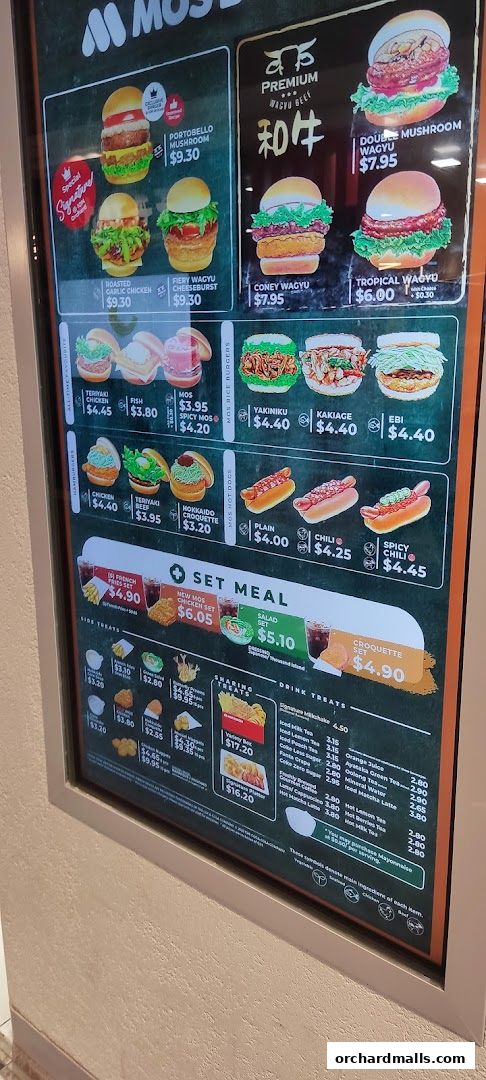 A menu board displaying various burgers, rice burgers, hot dogs, set meals, and drinks from MOS Burger.