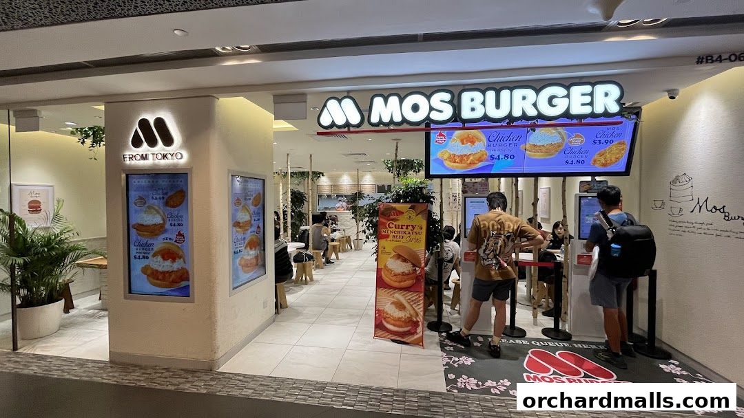 The exterior of a MOS Burger restaurant with menu displays and customers.