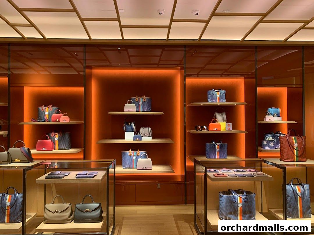 Interior view of a luxury handbag store showcasing various bags on shelves and in display cases.