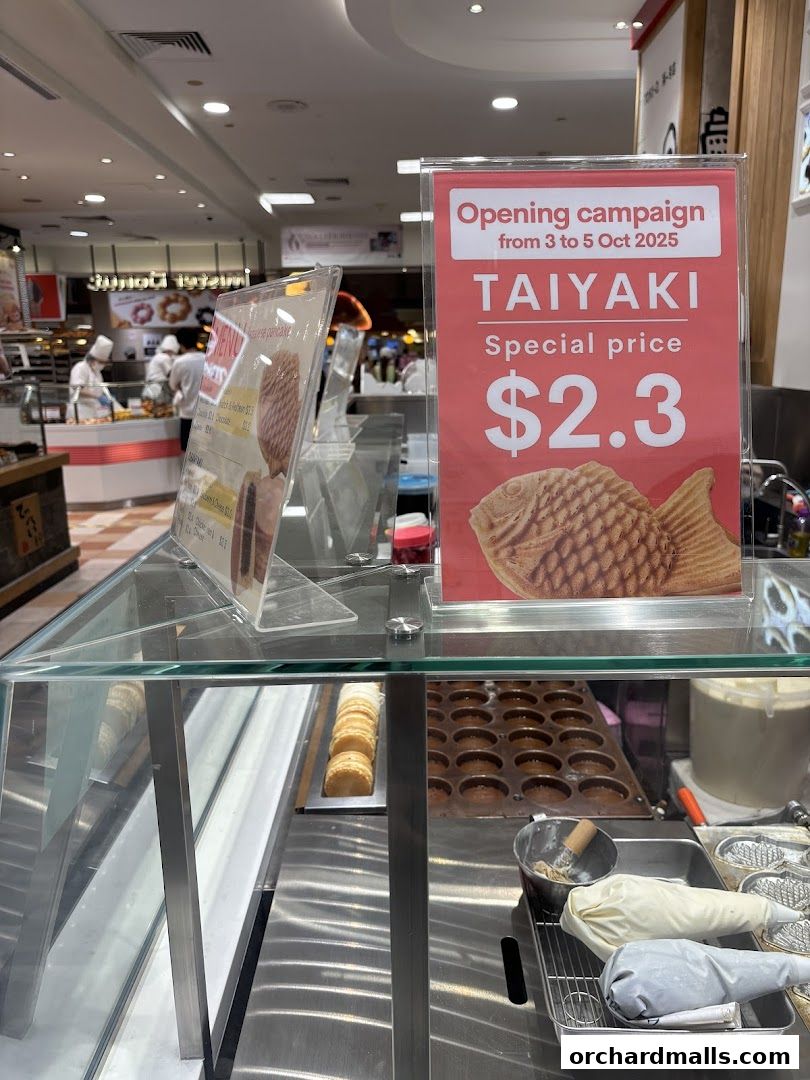 A display counter with Taiyaki Japanese pancakes and an opening campaign sign.