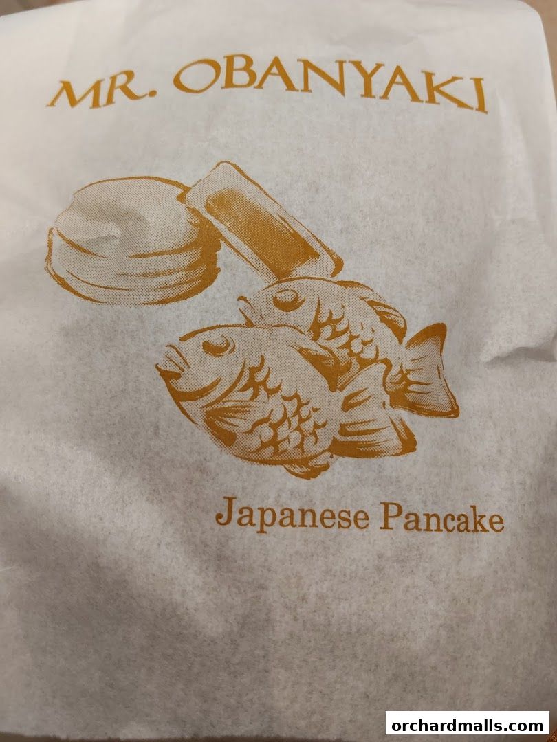 A white paper bag with the Mr. Obanyaki logo and Japanese pancake illustration.