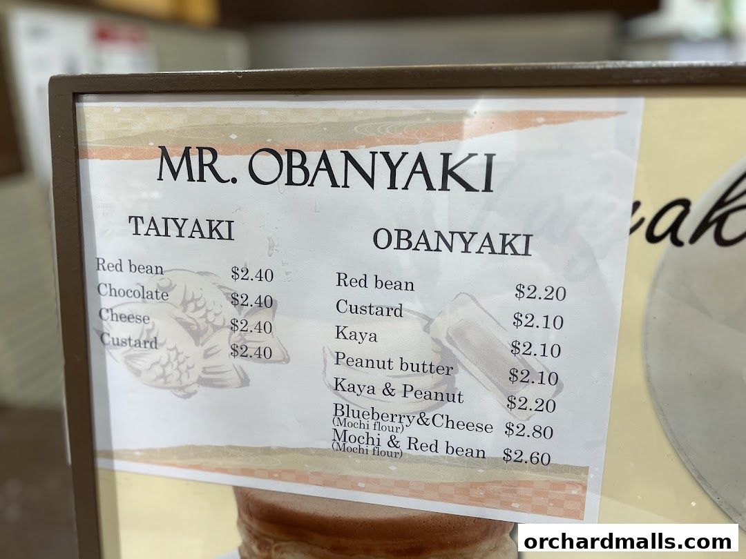 A menu board displaying Taiyaki and Obanyaki pancake options and prices.