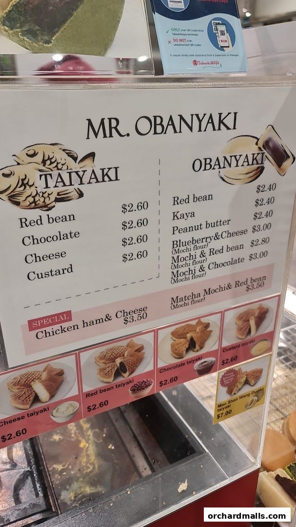 A menu board displaying various Taiyaki and Obanyaki flavors and prices.