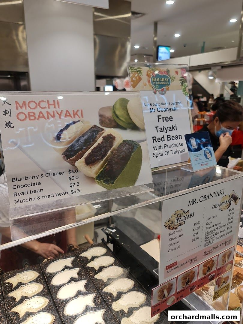 A display of Japanese pancakes (Taiyaki) with various fillings and a special offer.