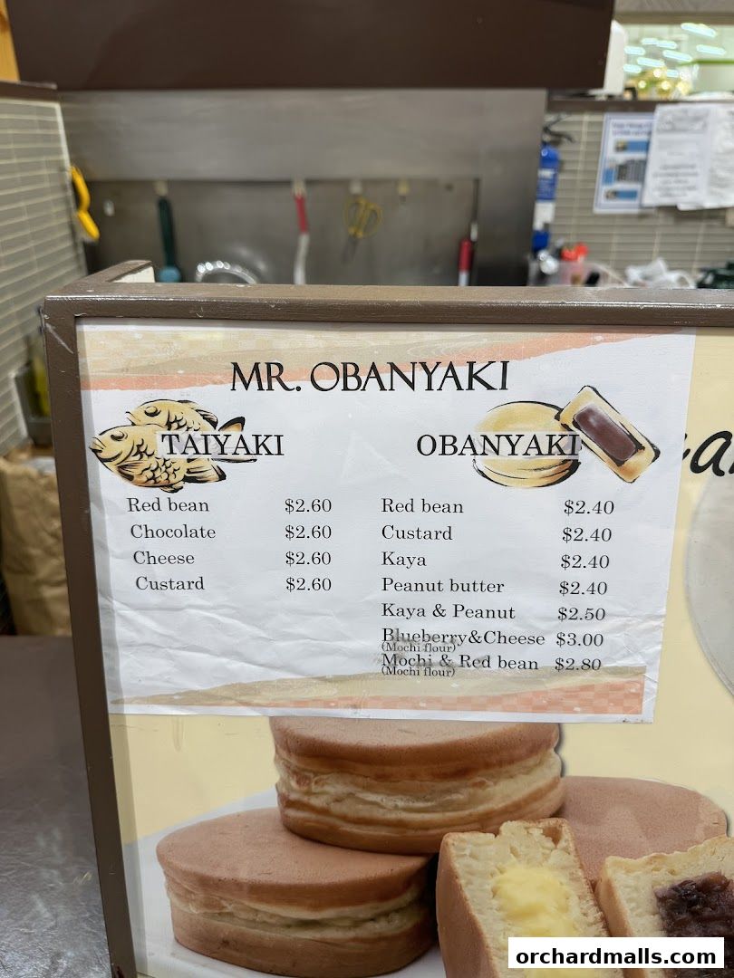 A menu board for Mr. Obanyaki featuring Taiyaki and Obanyaki pancakes with various fillings.