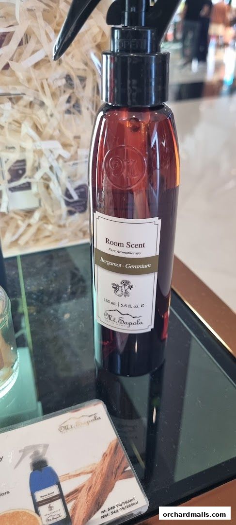 A bottle of Mt. Sapola Bergamot-Geranium room scent with product information.