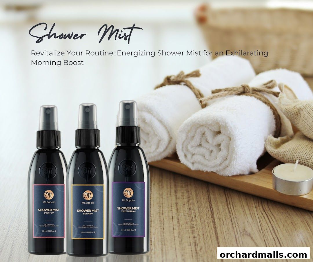 Three bottles of Mt. Sapola shower mist with rolled towels and a candle.