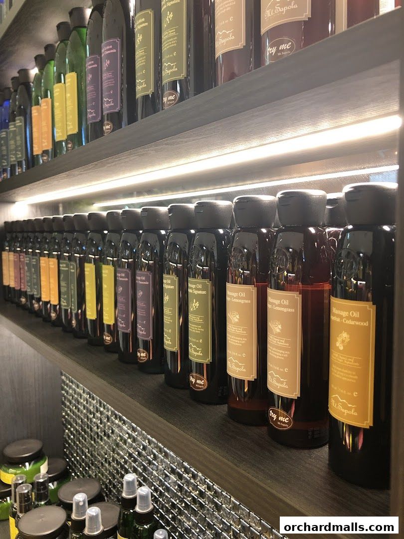 Shelves stocked with various bottles of massage oils and lotions from Mt. Sapola.