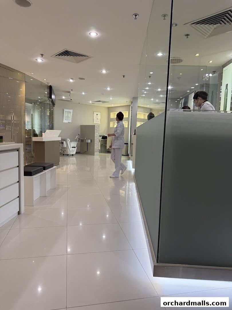 Interior view of a clean, modern beauty clinic with staff at the reception.