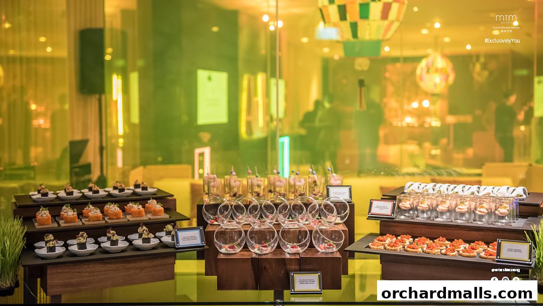 A display of various appetizers and desserts, with a backdrop of a modern, warmly lit interior.