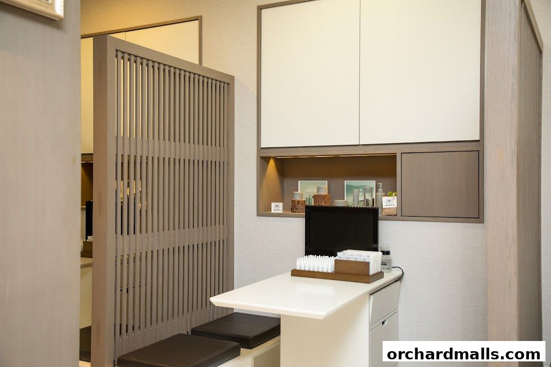 Interior view of a modern skincare consultation area with a desk and display shelves.