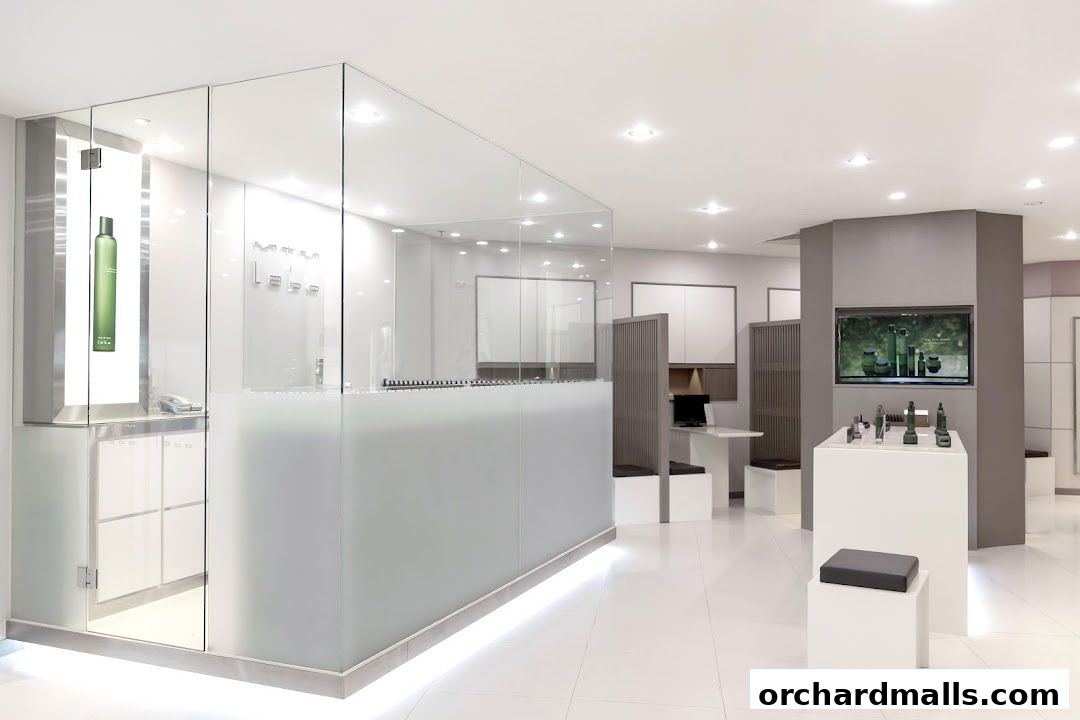 Interior view of a modern, clean retail space with glass displays and product shelves.