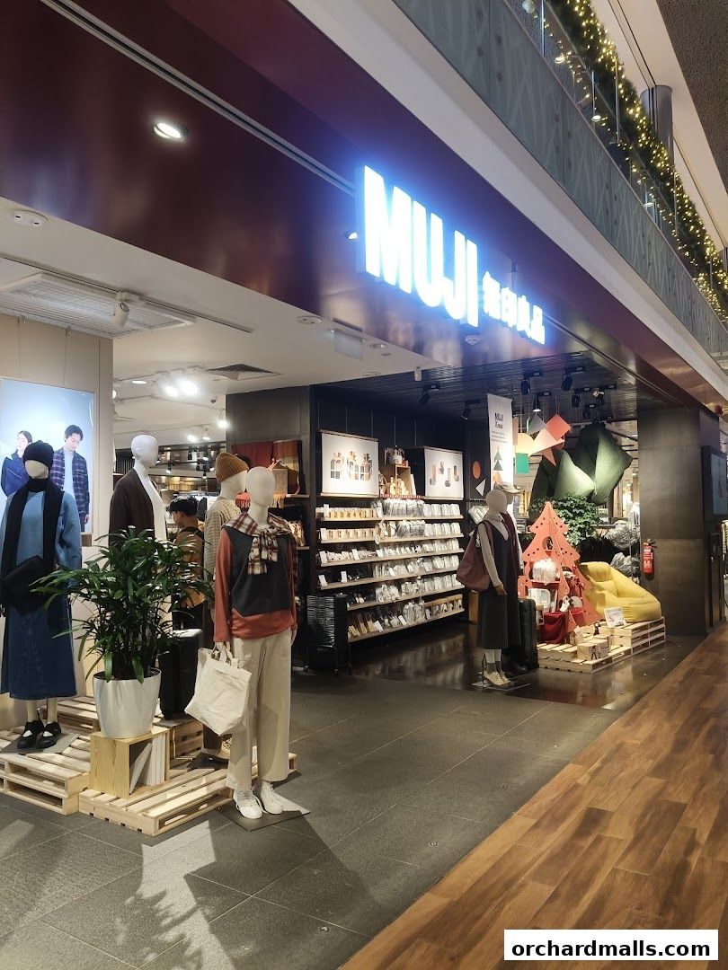 The MUJI store entrance displays mannequins and shelves stocked with products.
