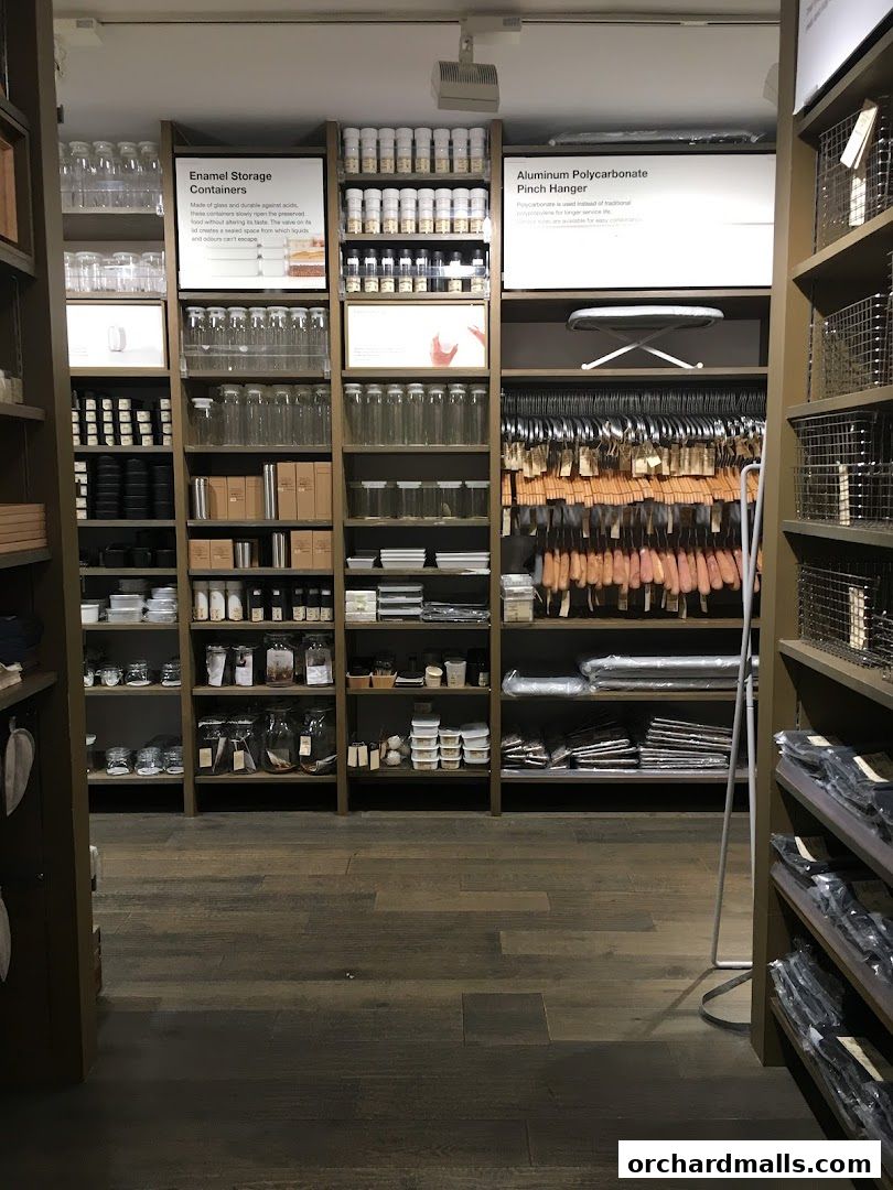 Interior view of a MUJI store showcasing various storage containers and hangers.