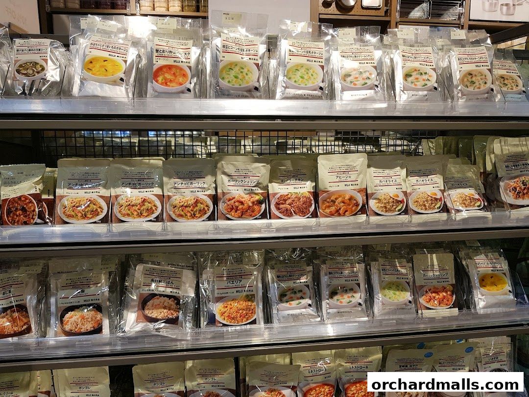 Shelves stocked with various packaged Muji instant meals and soups.