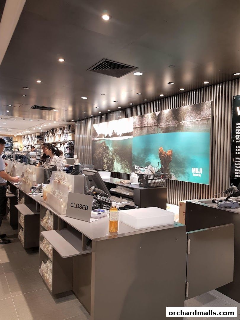 Interior shot of a MUJI store with checkout counters and displays.