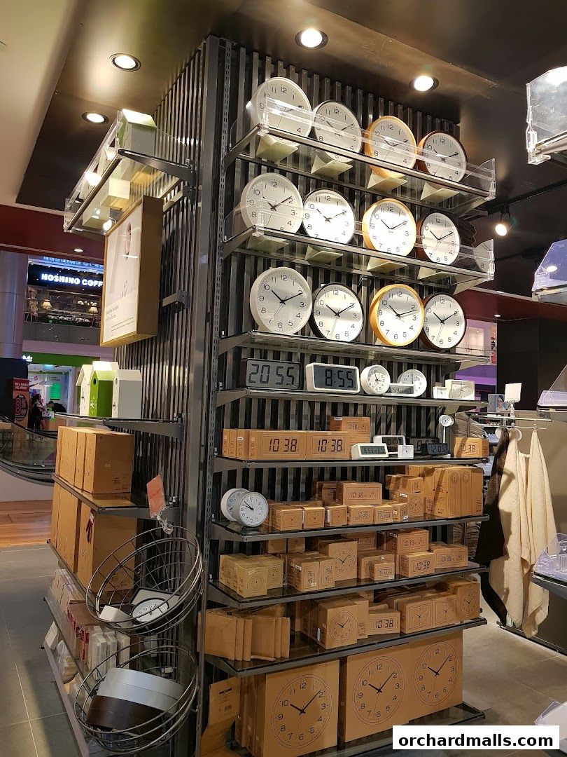 A display of various clocks and timekeeping devices on shelves in a retail store.
