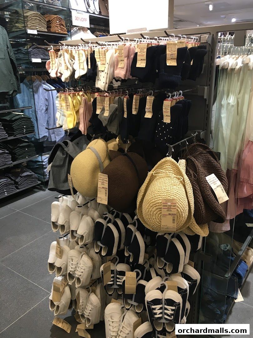 A display of socks, hats, and shoes in a retail store.