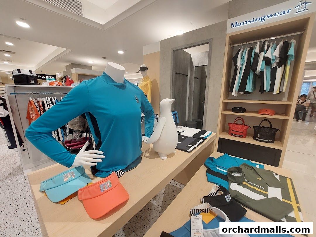 Munsingwear shop interior displaying apparel, accessories, and a penguin mascot.