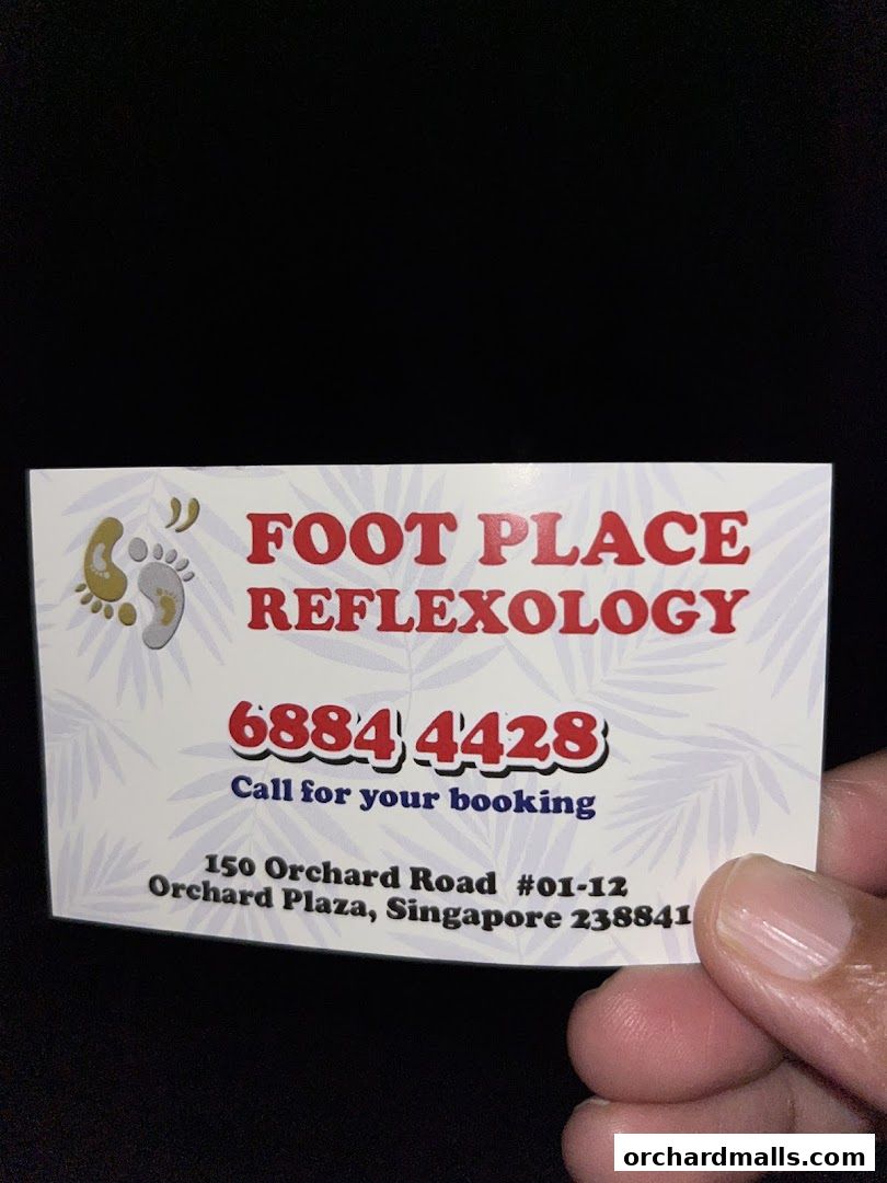 A business card for Foot Place Reflexology with contact and address details.